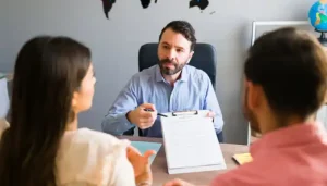 Findanyagent Dubai visit visa consultant explaining an application form on a clipboard to a couple in an office.
